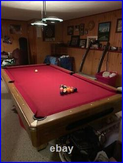 8 FT 3 piece slate pool table, comes with pool cues. Do not use it anymore