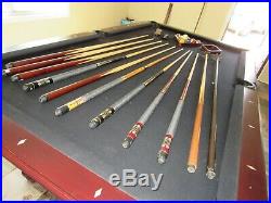 8 foot canon pool table with pool cues balls and triangles