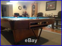 9 foot Brunswick Gold Crown 3 pool table with balls, rack, and two bar cues