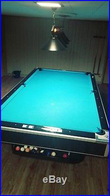 9 foot Brunswick slate pool table with ball return. New bumpers and felt