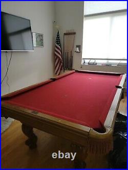 Brunswick pool table, rack, chairs, pictures and cues