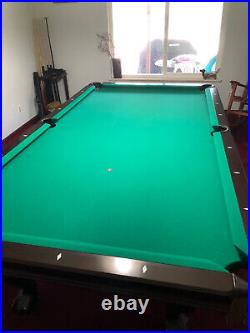 Lightly used Brunswick pool table 9' in good shape, slate playing surface