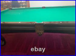 Lightly used Brunswick pool table 9' in good shape, slate playing surface