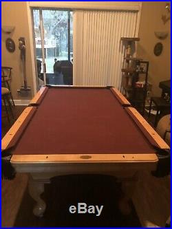 Olhausen 8' slate pool table, with cues and accessories including accessories