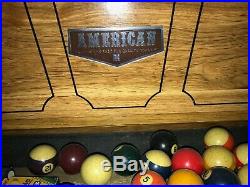 Pool table & pool balls, 9 cue sticks, stick rack, custom 2 piece plywood cover